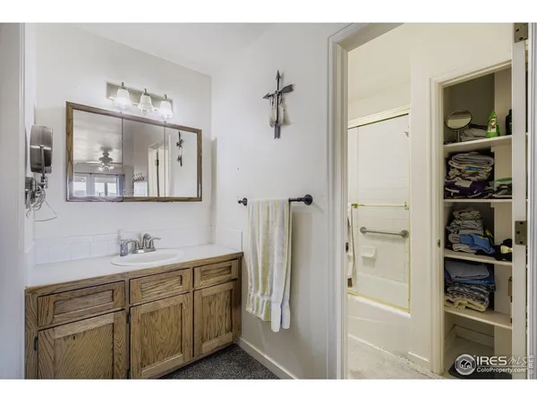 a bathroom with a sink a mirror and a shower