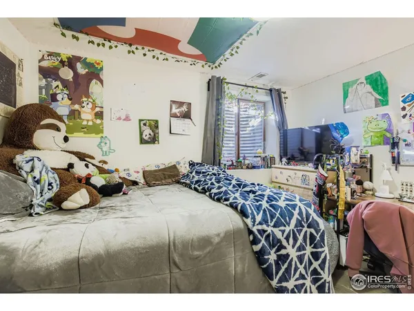 a bedroom with bed and window