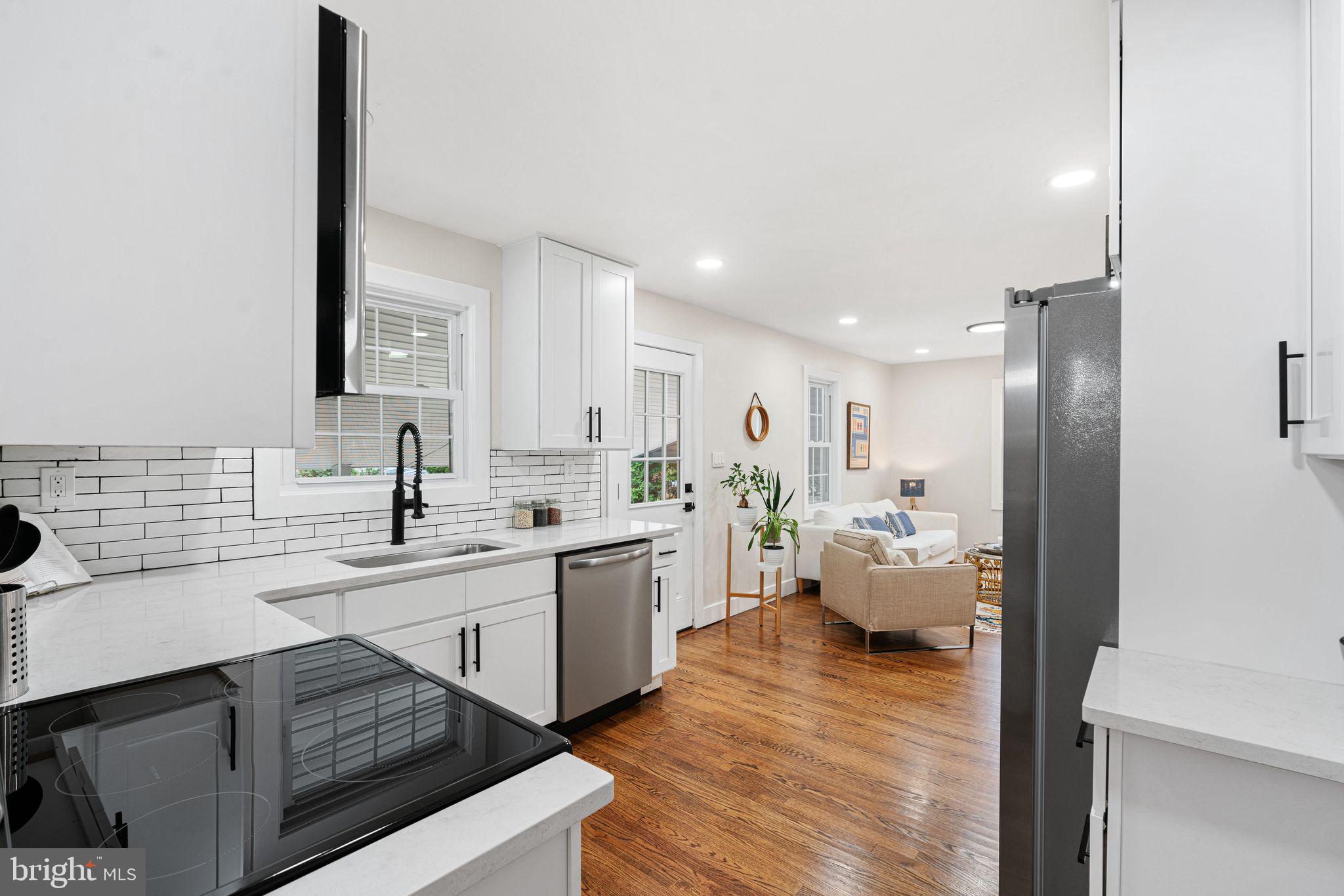 116 Rhoads Avenue Haddonfield, NJ 08033 - Photo 7 of 29 a kitchen with sink cabinets and wooden floor