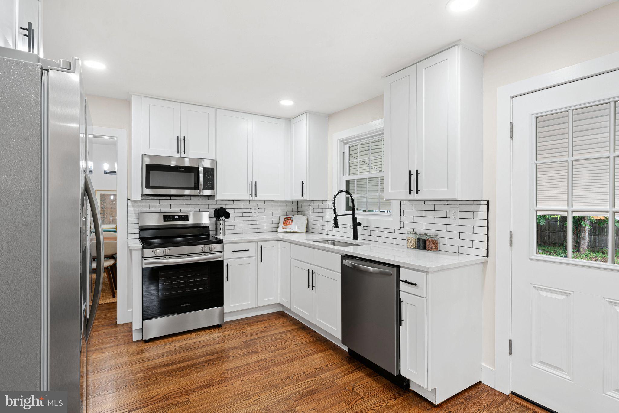 116 Rhoads Avenue Haddonfield, NJ 08033 - Photo 8 of 29 a kitchen with stainless steel appliances granite countertop a stove top oven a sink and cabinets
