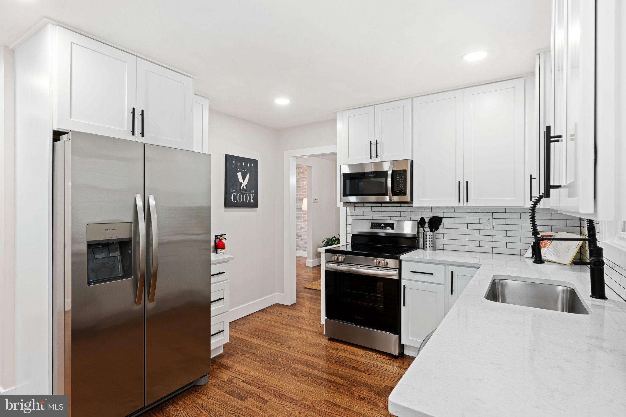 116 Rhoads Avenue Haddonfield, NJ 08033 - Photo 9 of 29 a kitchen with stainless steel appliances a refrigerator sink and microwave
