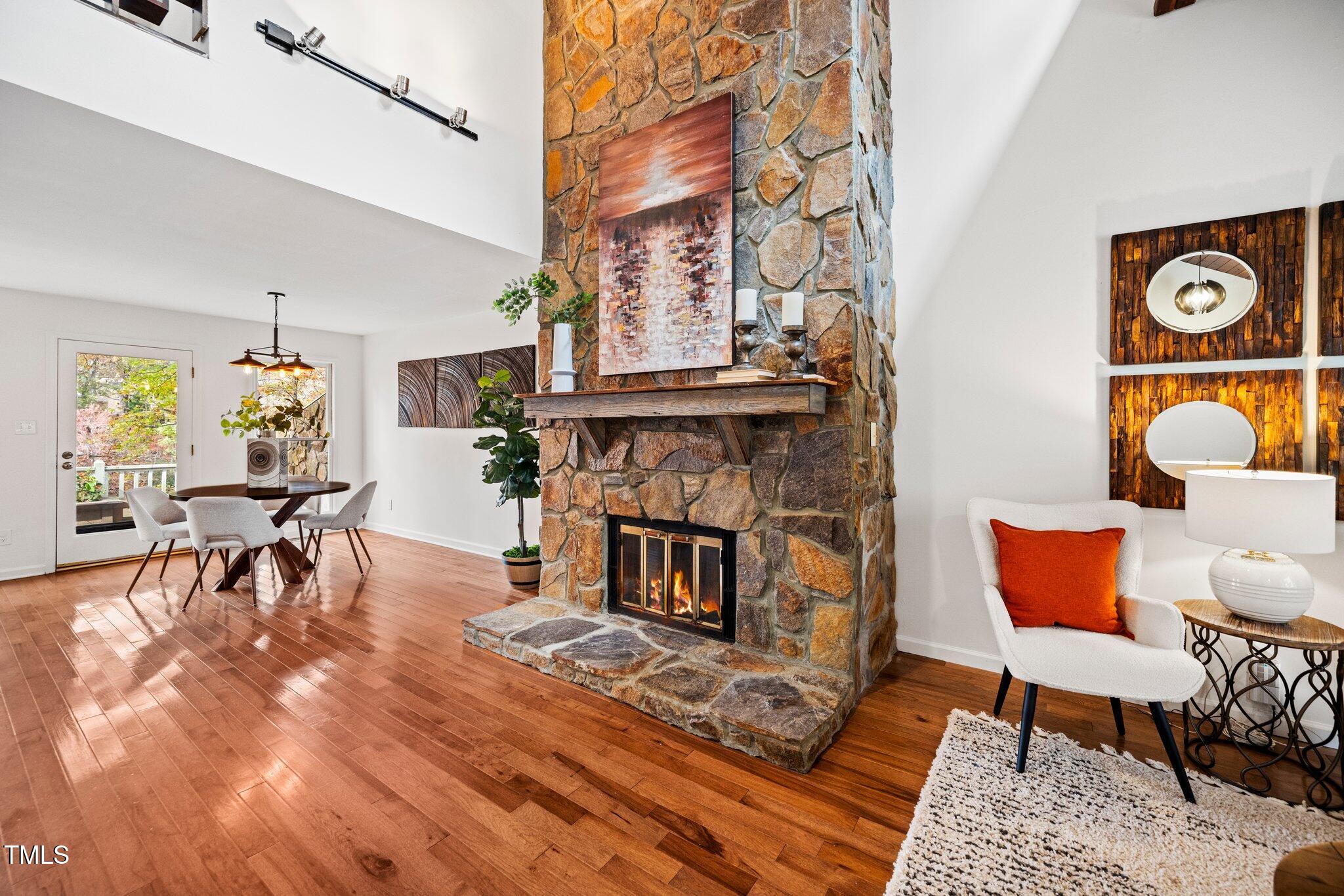 7827 Breckon Way Raleigh, NC 27615 - Photo 8 of 28 a living room with furniture and a fireplace