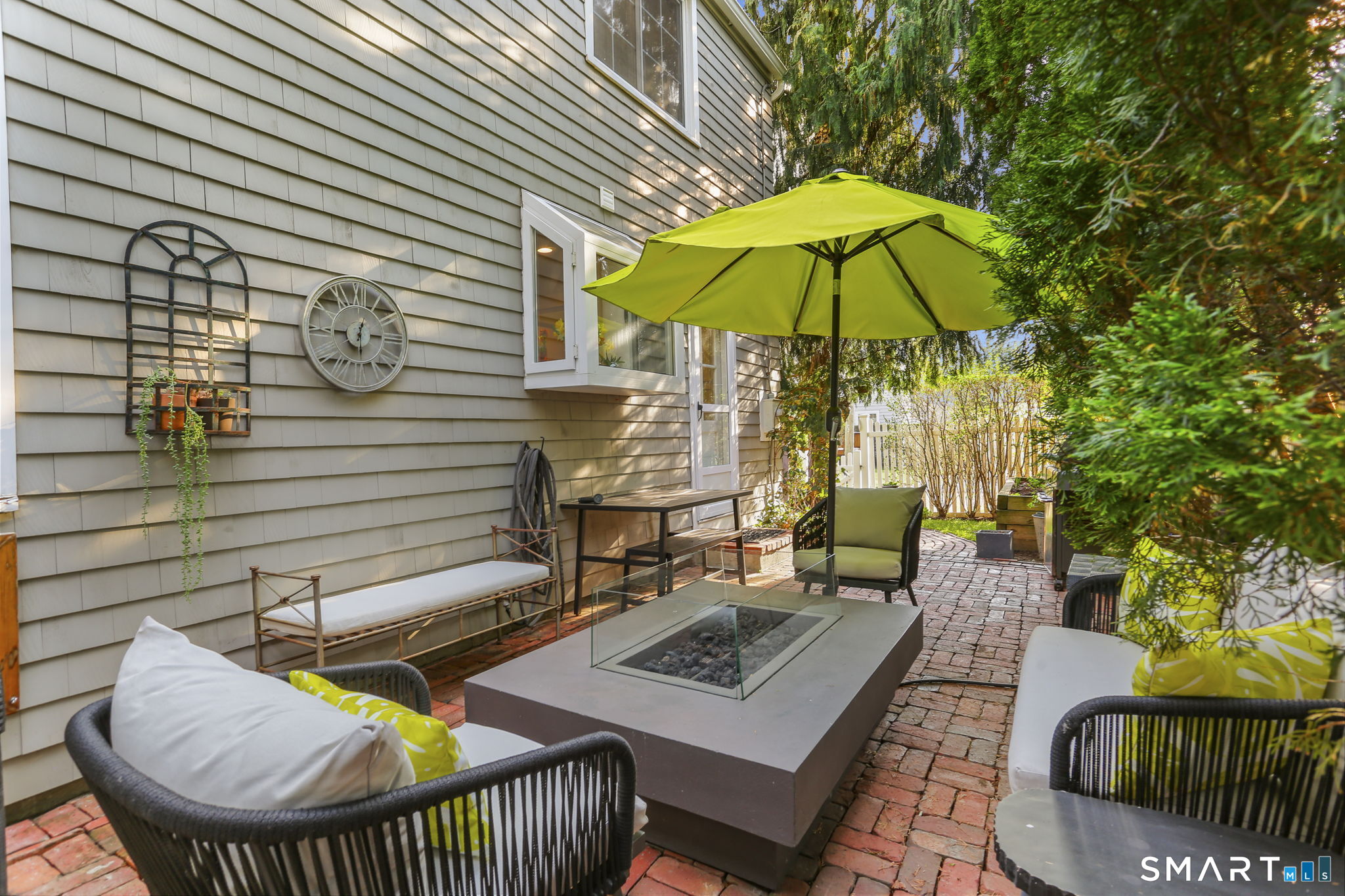 29 Old Saugatuck Road Norwalk, CT 06855 - Photo 26 of 34 a view of a patio with couches chairs under an umbrella