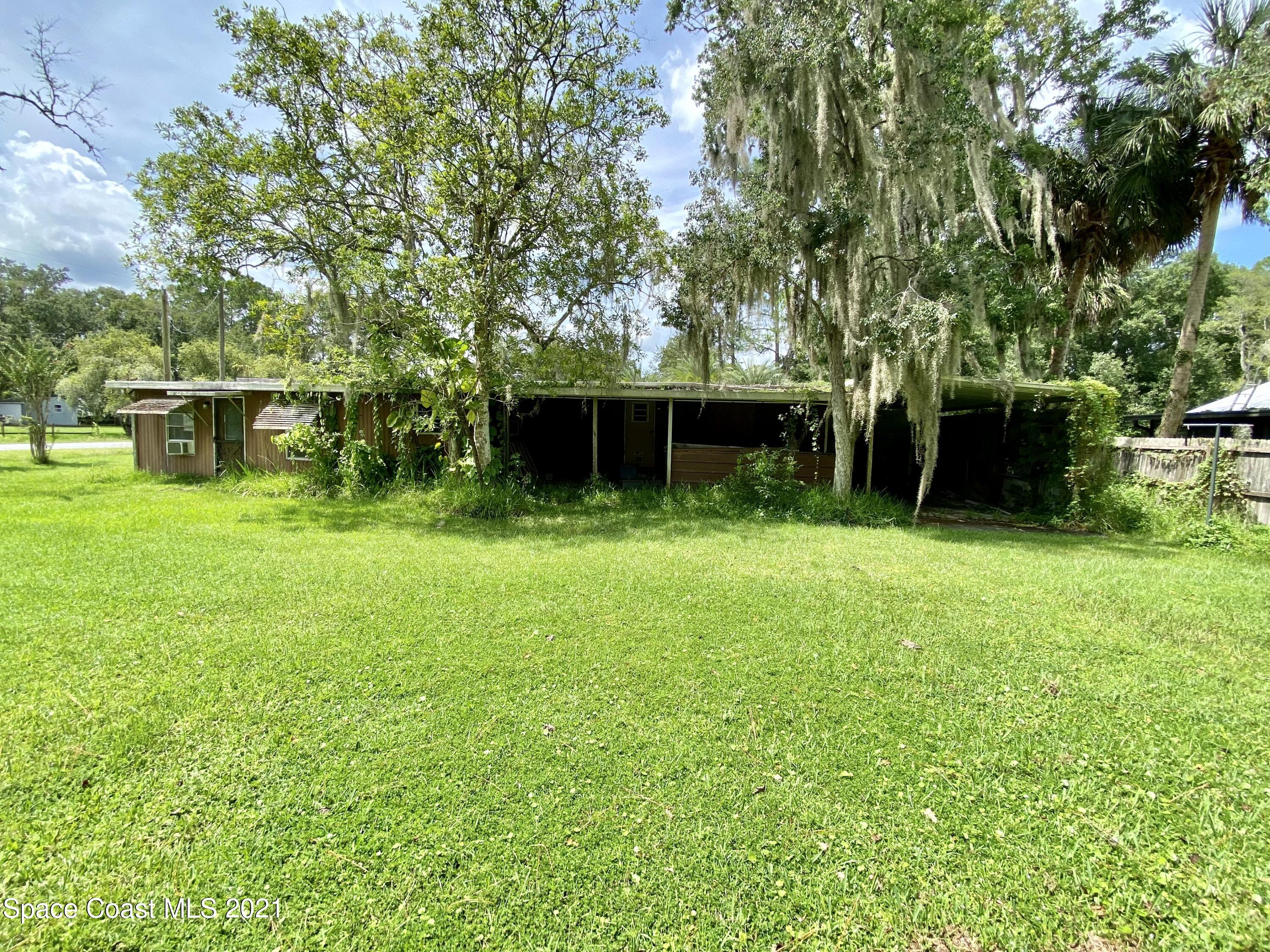 23903 Coon Road Astor, FL 32102 - Photo 3 of 19 a backyard of a house with entertaining space