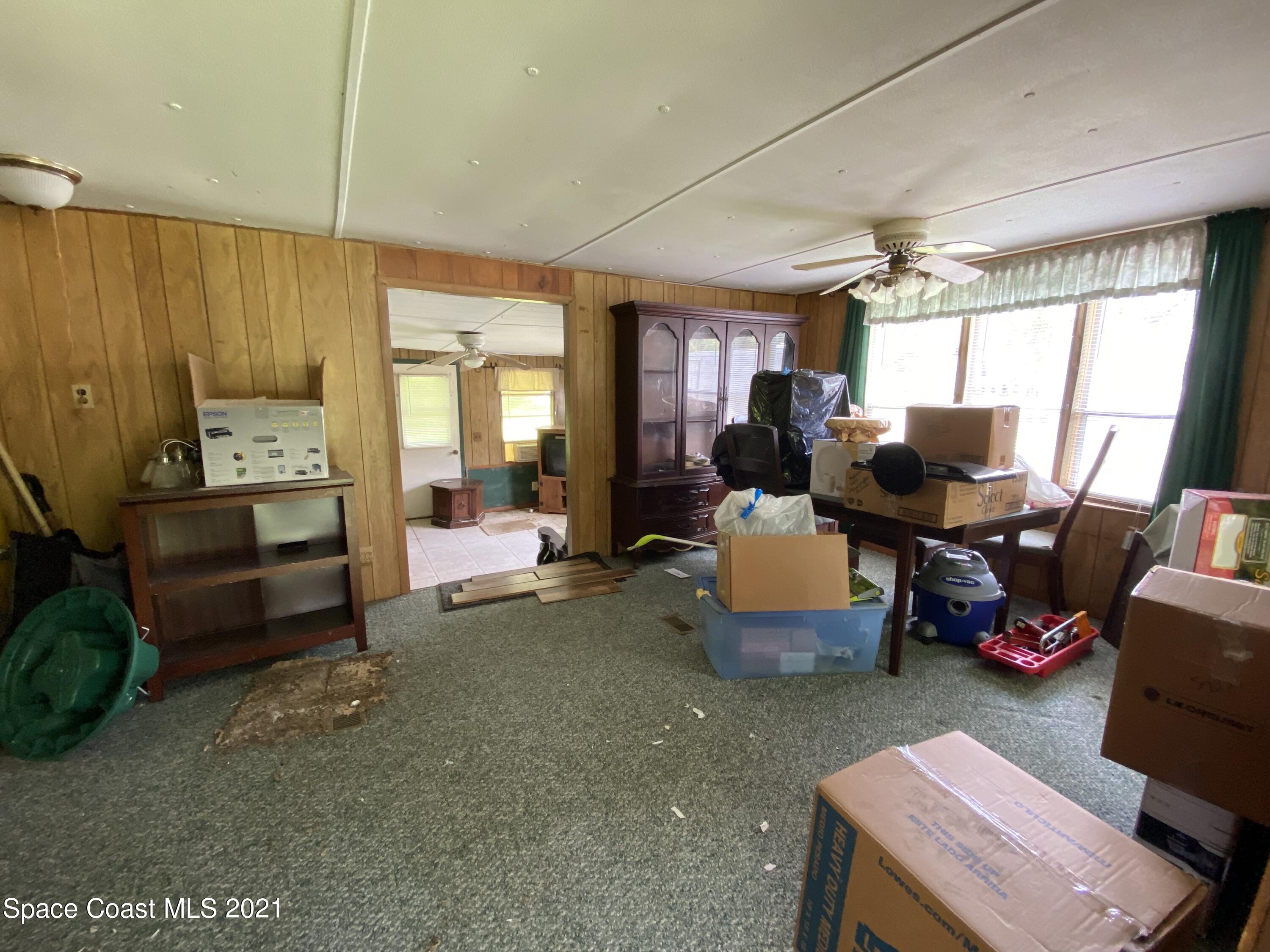 23903 Coon Road Astor, FL 32102 - Photo 8 of 19 a living room with furniture and a large window