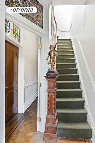 a view of a room with a ceiling fan and wooden floor