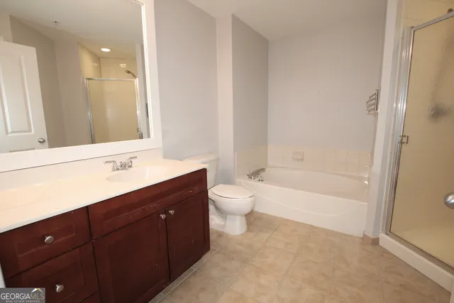 a bathroom with a tub sink toilet and mirror