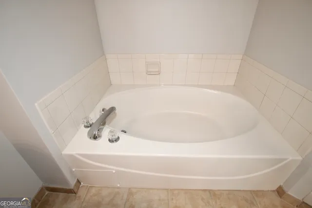 a white bath tub sitting in a bathroom