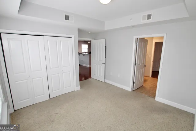 an empty room with closet area