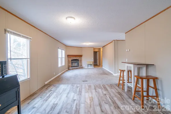 a furnished livingroom with windows and wooden floor