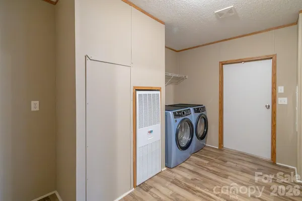 a view of a bedroom with washer and dryer