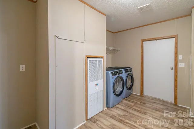 a view of a bedroom with washer and dryer