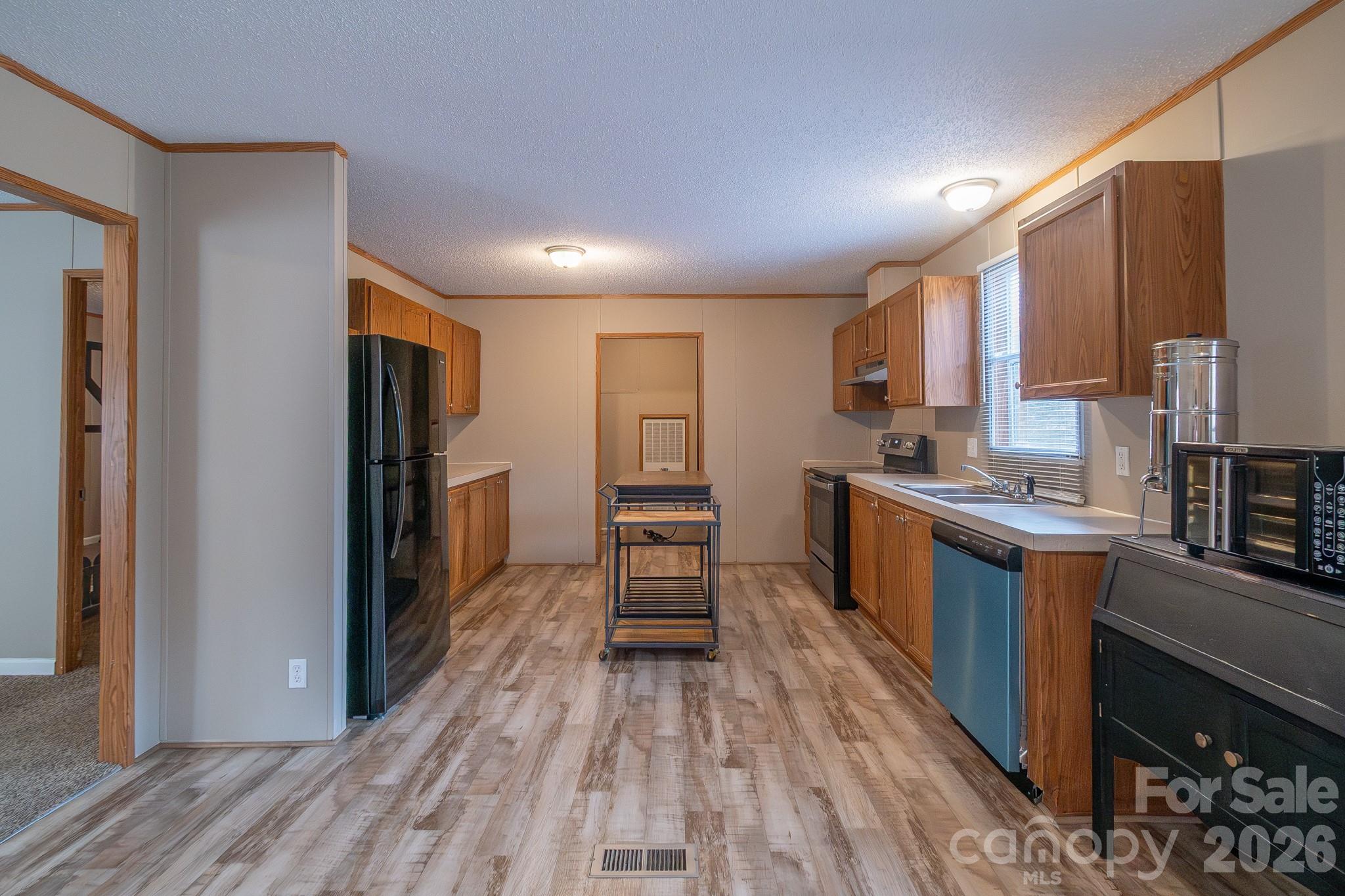 6706 Patrick Highway Patrick, SC 29584 - Photo 25 of 43 a kitchen with kitchen island wooden floors appliances and cabinets