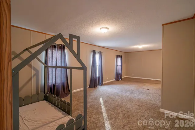 a view of hallway with stairs and wooden floor
