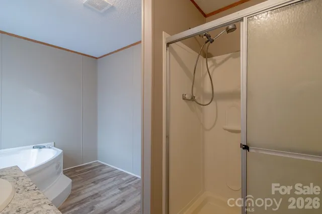 a bathroom with a shower and a sink