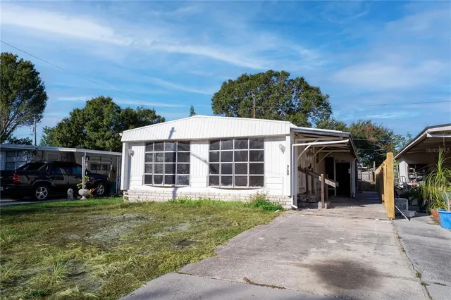 a view of a house with yard and sitting area