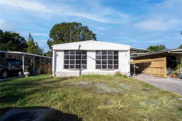 a view of a house with backyard and porch