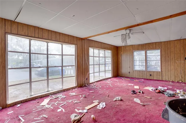 a bed room with a bed and a large window