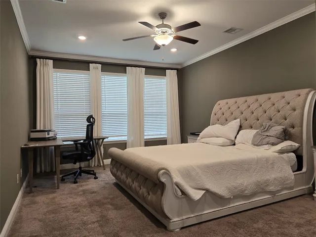 a bedroom with a large bed and a chandelier