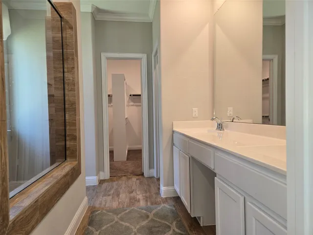 a bathroom with a double vanity sink and a mirror