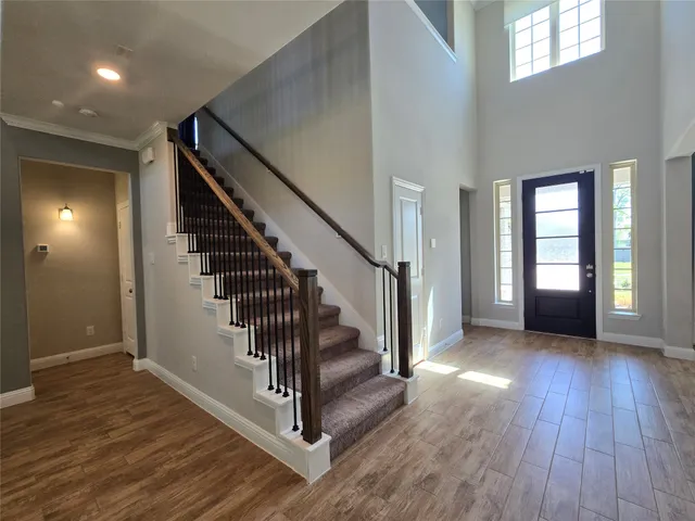 a view of an entryway with wooden floor and stairs