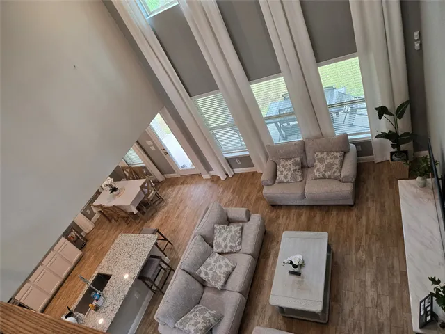 a living room with furniture and a floor to ceiling window