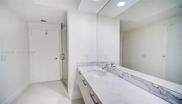 a bedroom with a bed and a shower