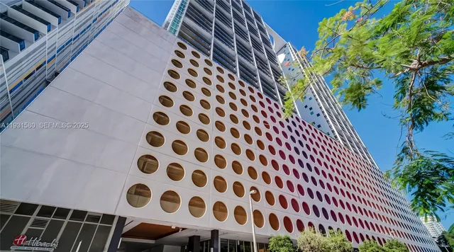 a view of a hallway with wooden floor and furniture