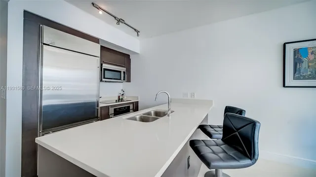 a kitchen with a refrigerator and a sink