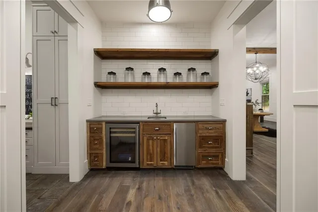 a kitchen with a sink a refrigerator and a stove