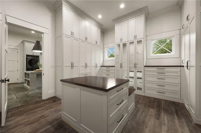 a bathroom with a granite countertop double vanity and a window