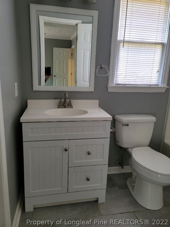 5042 Summer Ridge Road Fayetteville, NC 28303 - Photo 15 of 17 a bathroom with a toilet sink and mirror