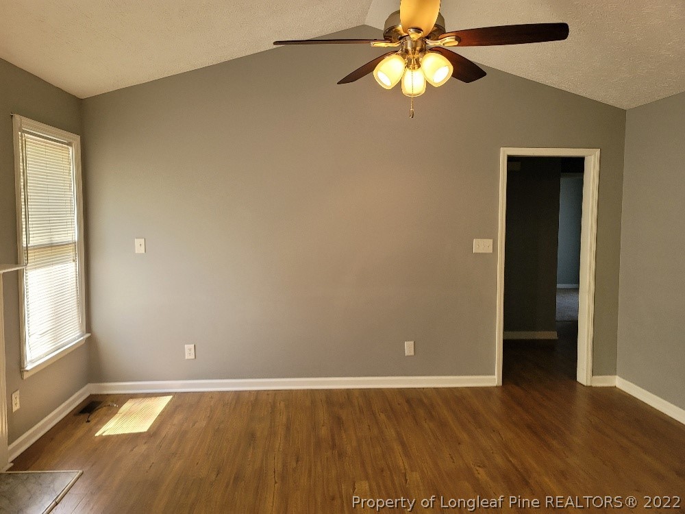 5042 Summer Ridge Road Fayetteville, NC 28303 - Photo 5 of 17 an empty room with wooden floor closet fan and windows