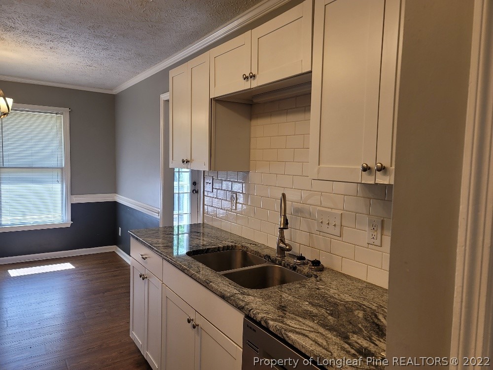 5042 Summer Ridge Road Fayetteville, NC 28303 - Photo 8 of 17 a kitchen that has a sink and a stove