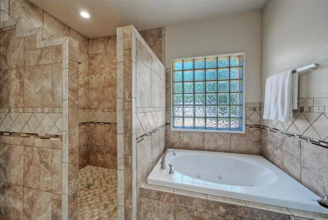 a bathroom with a bath tub and shower