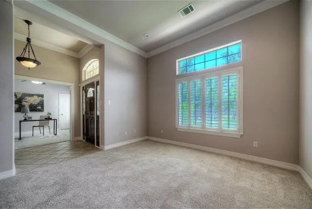 a dining room with furniture and window