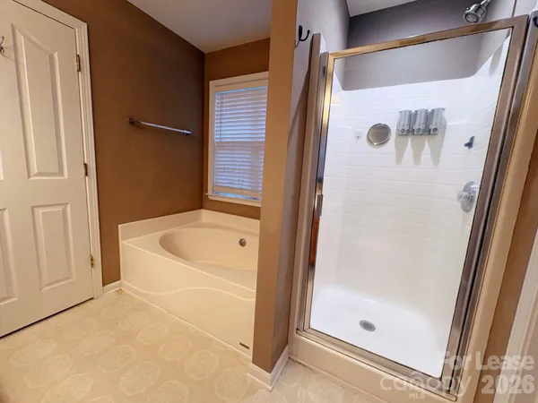 a bathroom with a bathtub and a shower