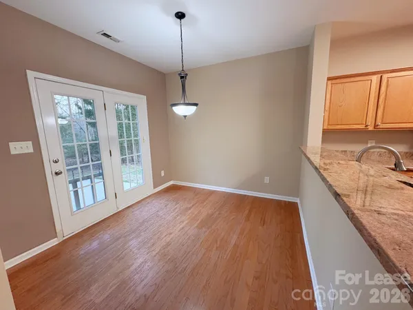 a view of a kitchen with a sink wooden floor and a window