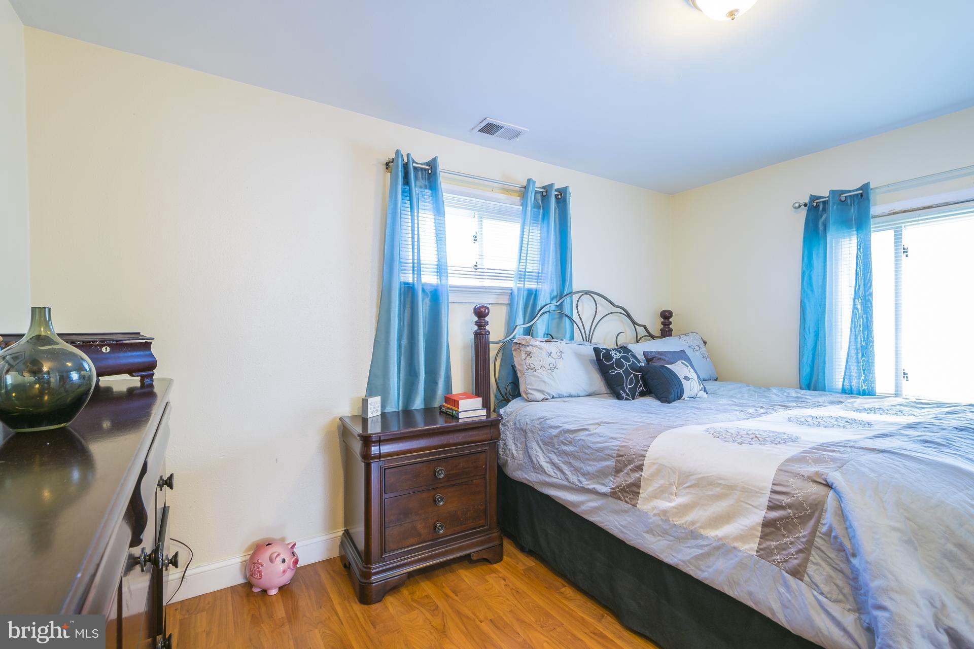 12217 Charles Road Silver Spring, MD 20906 - Photo 11 of 30 a bedroom with a bed and dresser