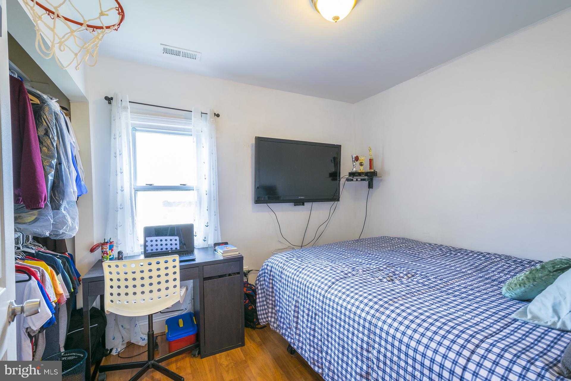 12217 Charles Road Silver Spring, MD 20906 - Photo 18 of 30 a bedroom with a bed and a flat screen tv