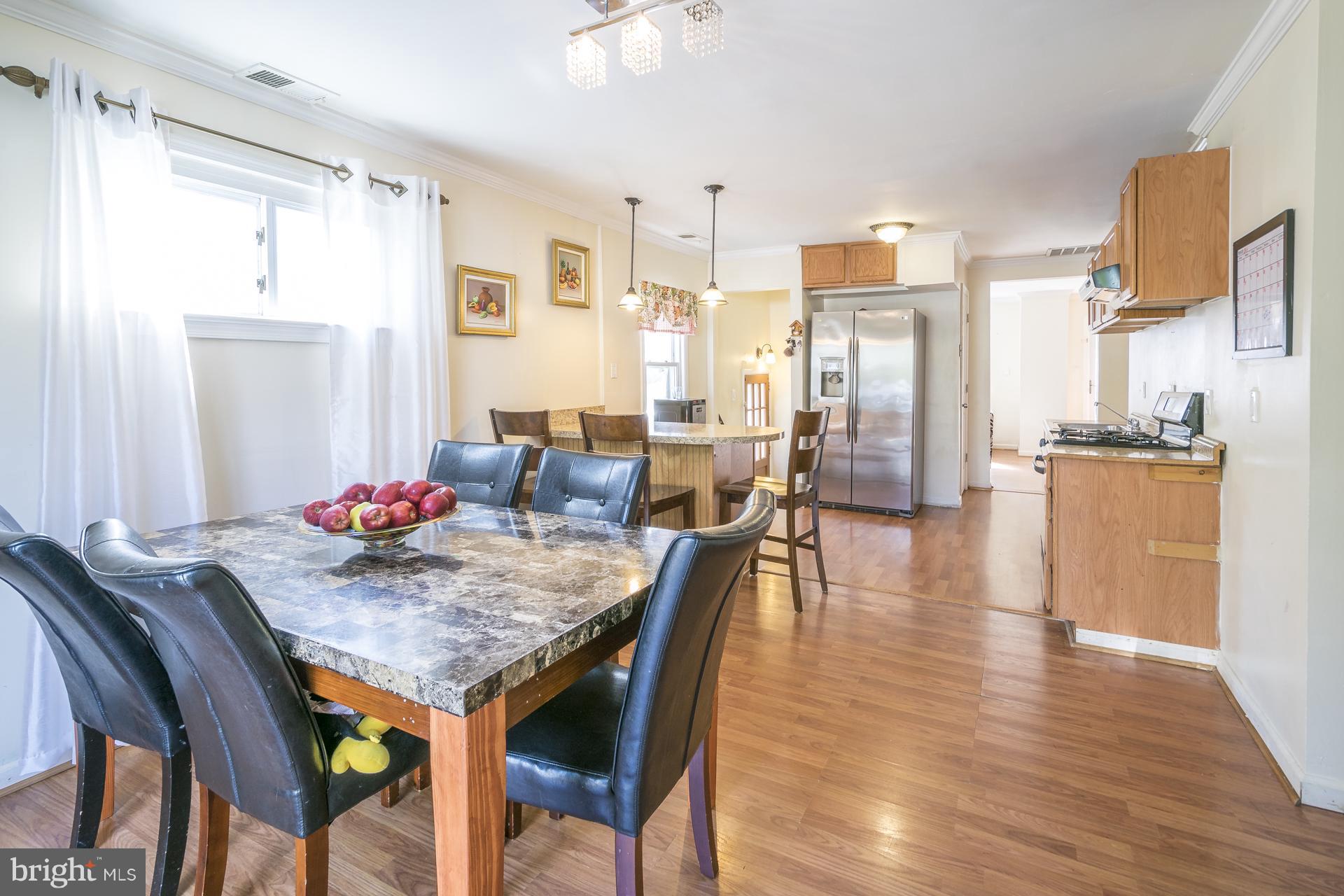 12217 Charles Road Silver Spring, MD 20906 - Photo 7 of 30 a view of a dining room with furniture and wooden floor