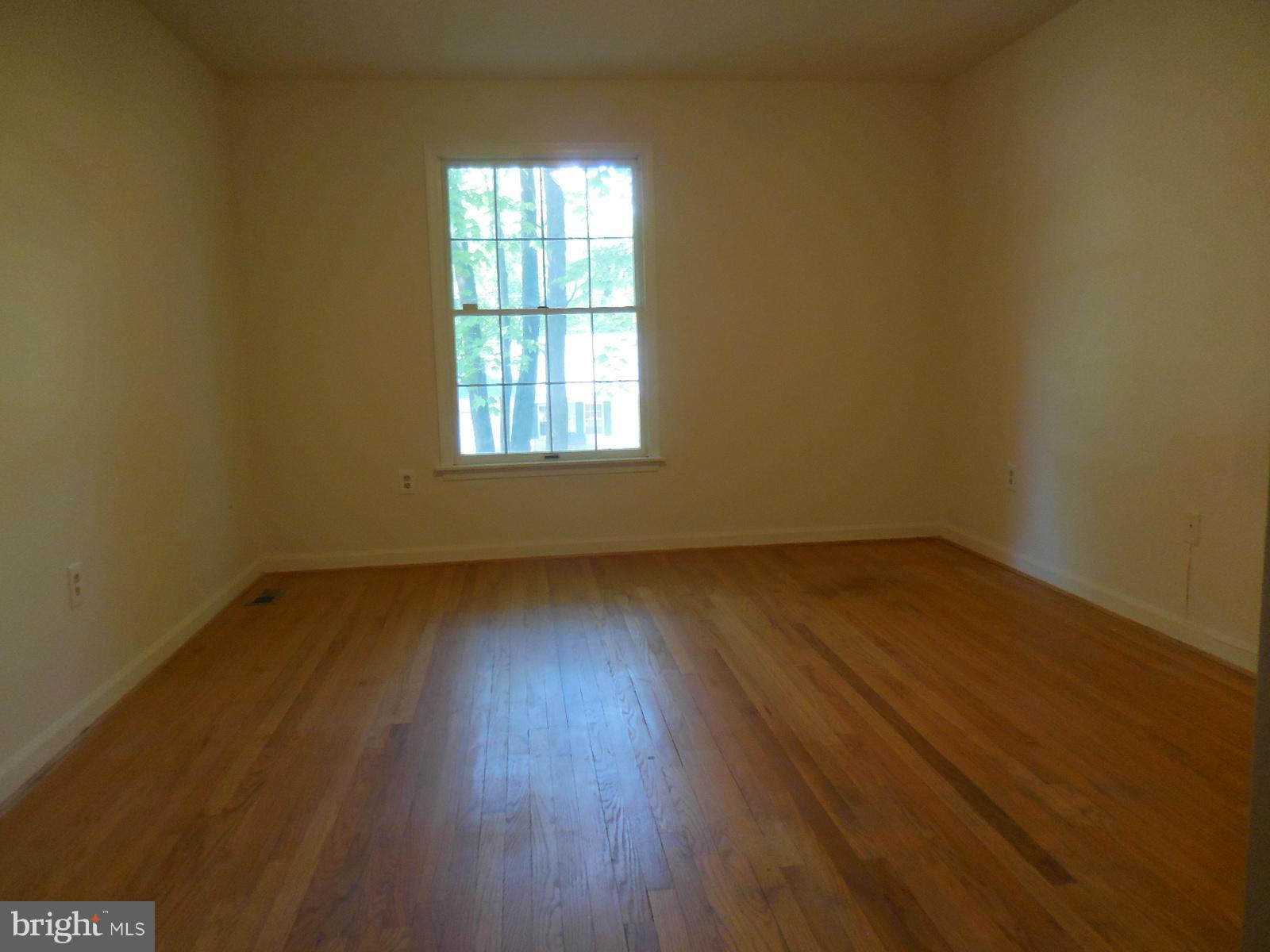 508 Holly Road Fort Washington, MD 20744 - Photo 12 of 29 an empty room with wooden floor and windows