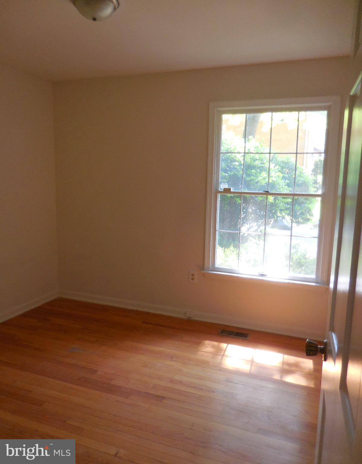 508 Holly Road Fort Washington, MD 20744 - Photo 10 of 29 a view of an empty room with wooden floor and a window