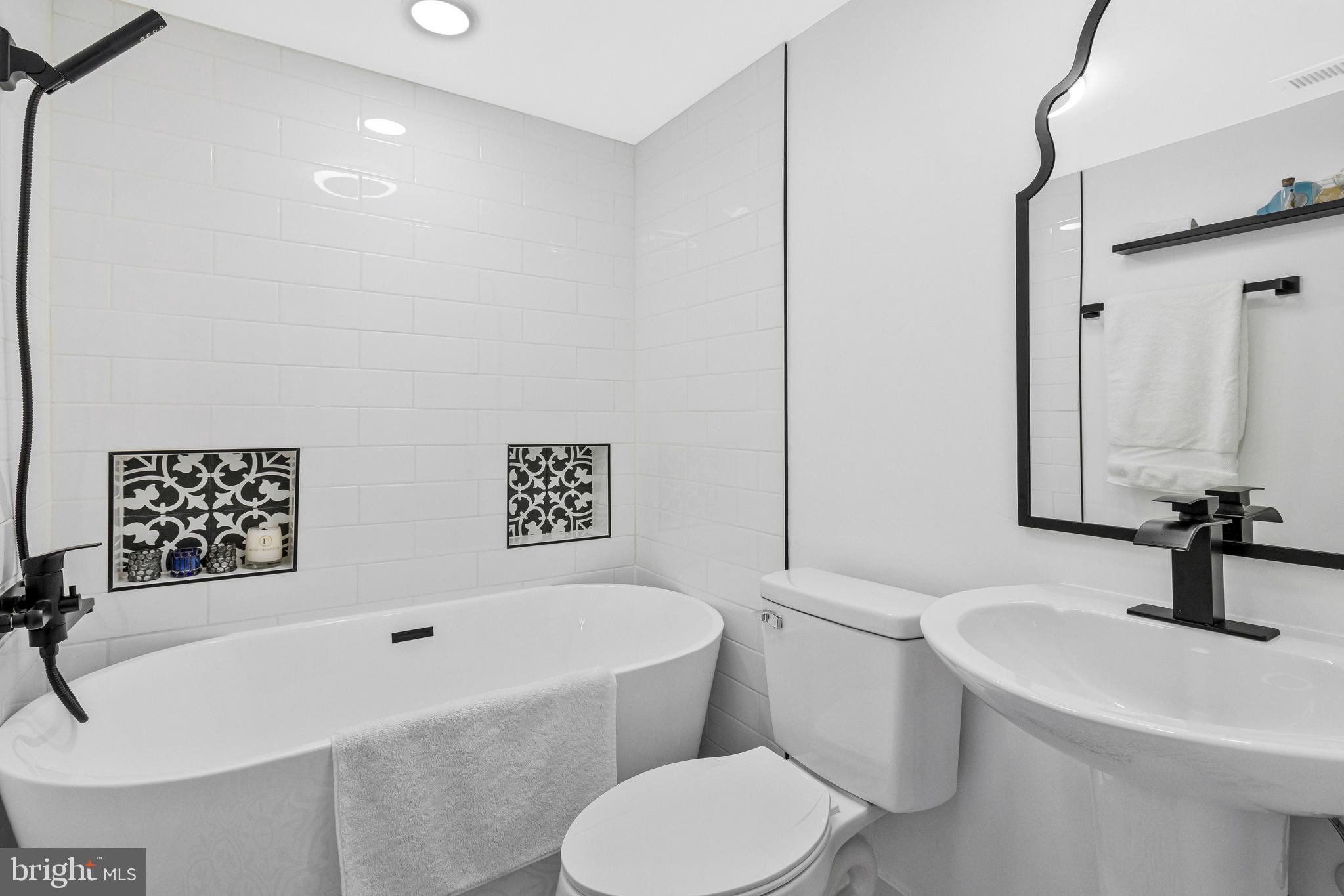 500 H Street Southwest Washington, DC 20024 - Photo 26 of 54 a bathroom with a sink a toilet and a mirror
