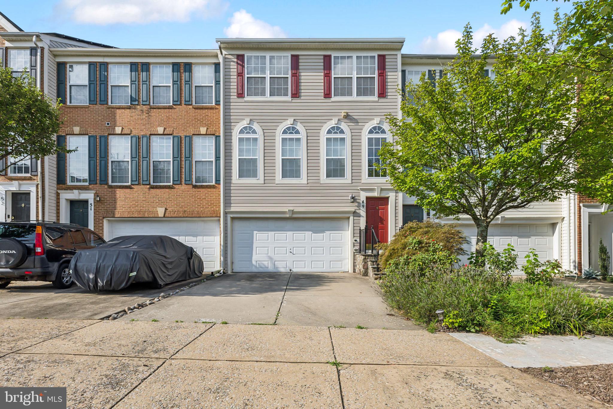 a front view of a residential apartment building with a yard