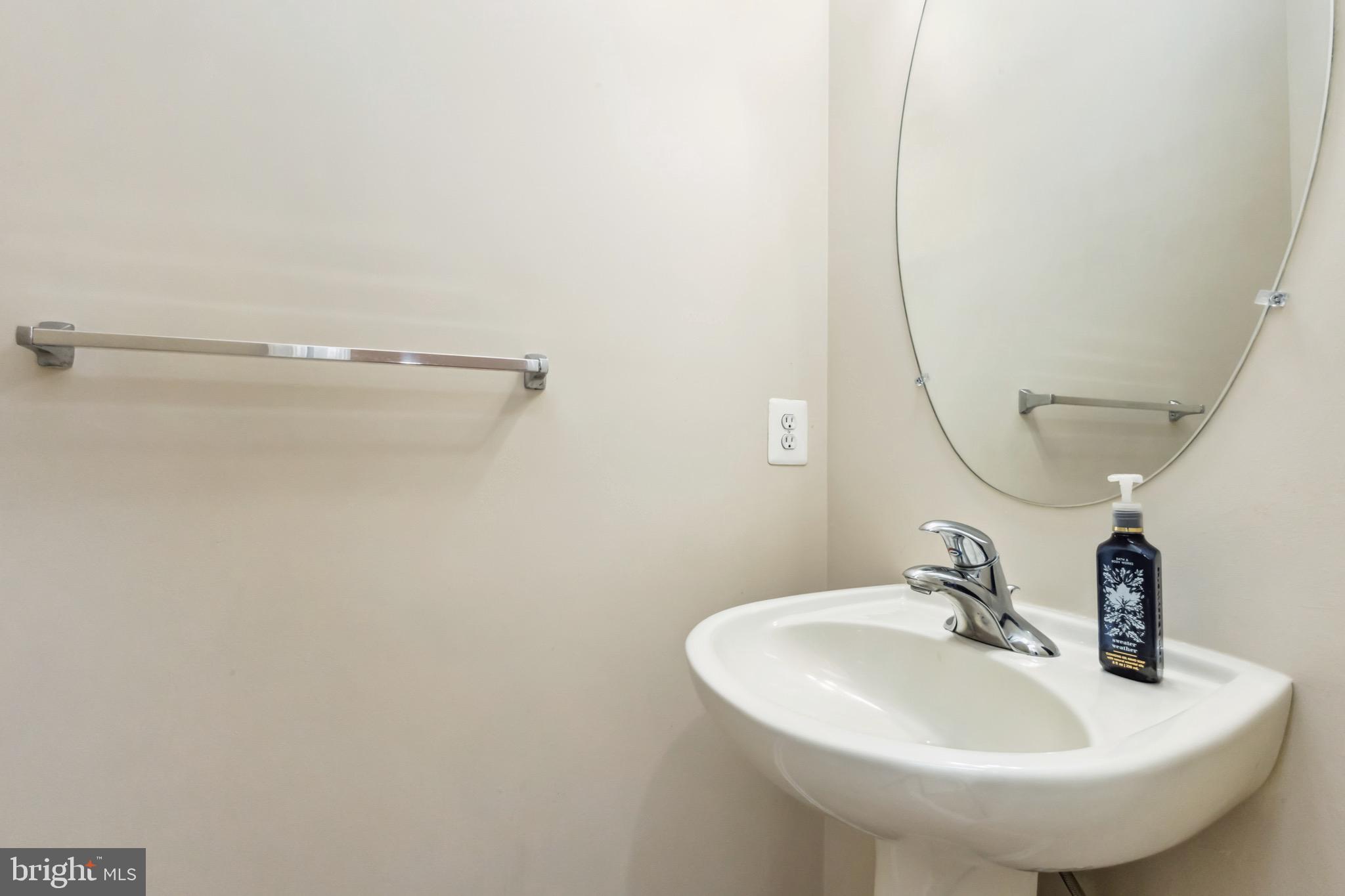 49 Inkberry Circle Gaithersburg, MD 20877 - Photo 4 of 25 a bathroom with a sink and a mirror