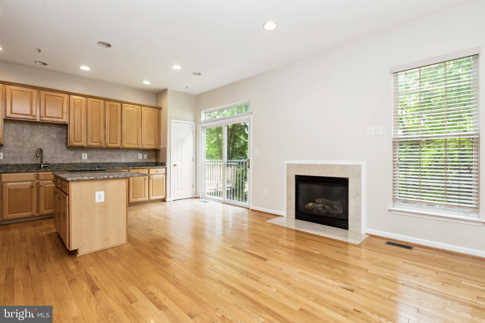 49 Inkberry Circle Gaithersburg, MD 20877 - Photo 6 of 25 a kitchen with granite countertop wooden floors a stove and a window