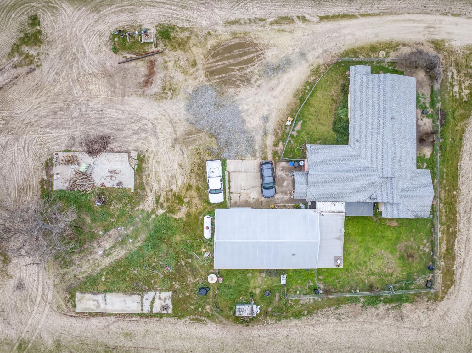 13370 South Bryan Avenue Caruthers, CA 93609 - Photo 17 of 28 an aerial view of a house with yard and parking