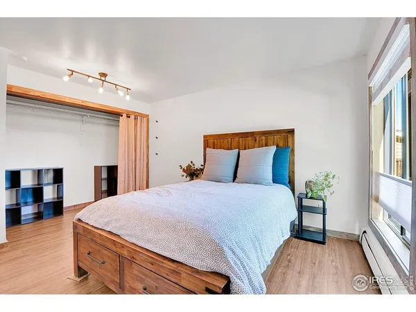 a bedroom with a bed and wooden floor