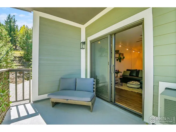 a balcony with furniture and a potted plant